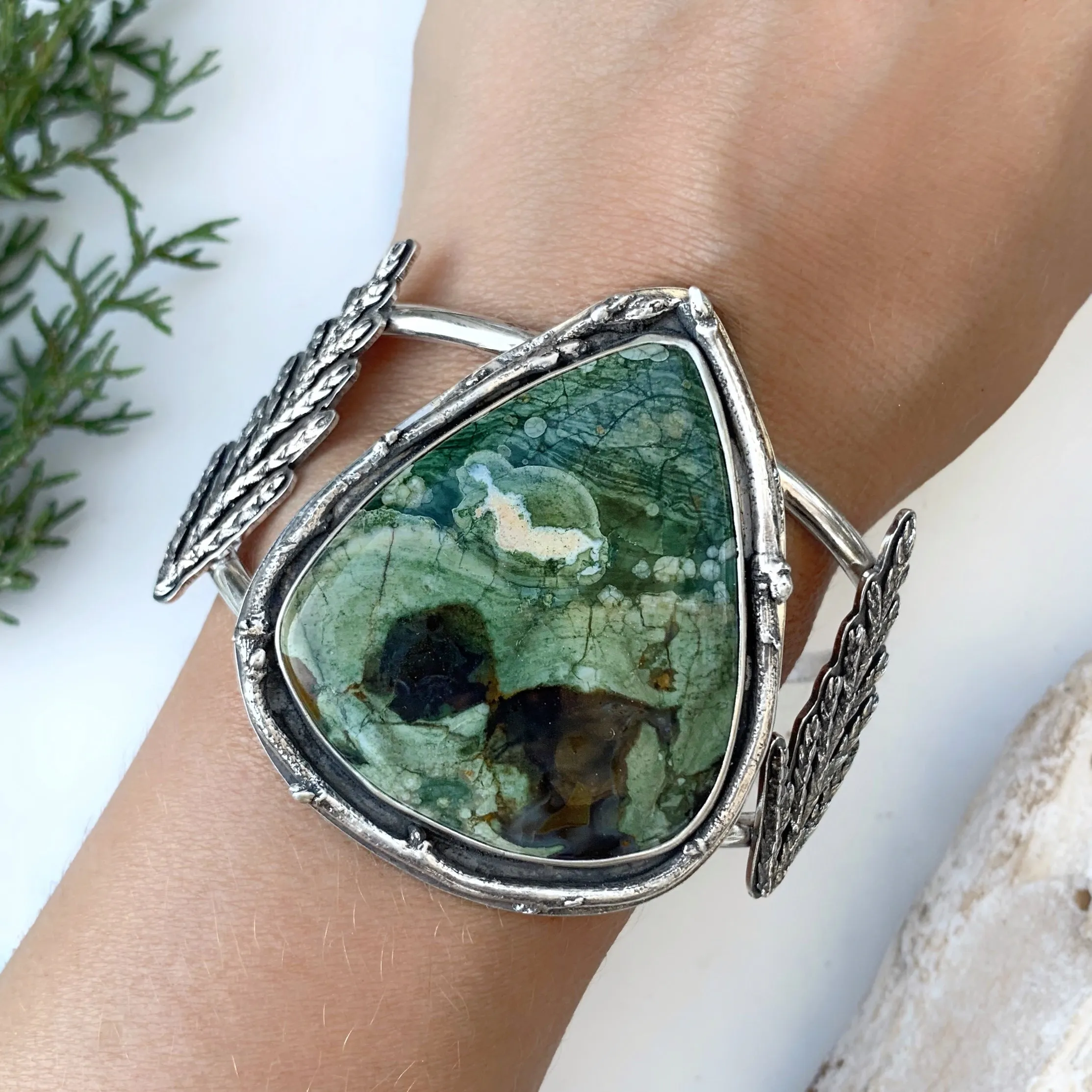 Opalized rhyolite cuff with cedar leaves and pine tree cut-out