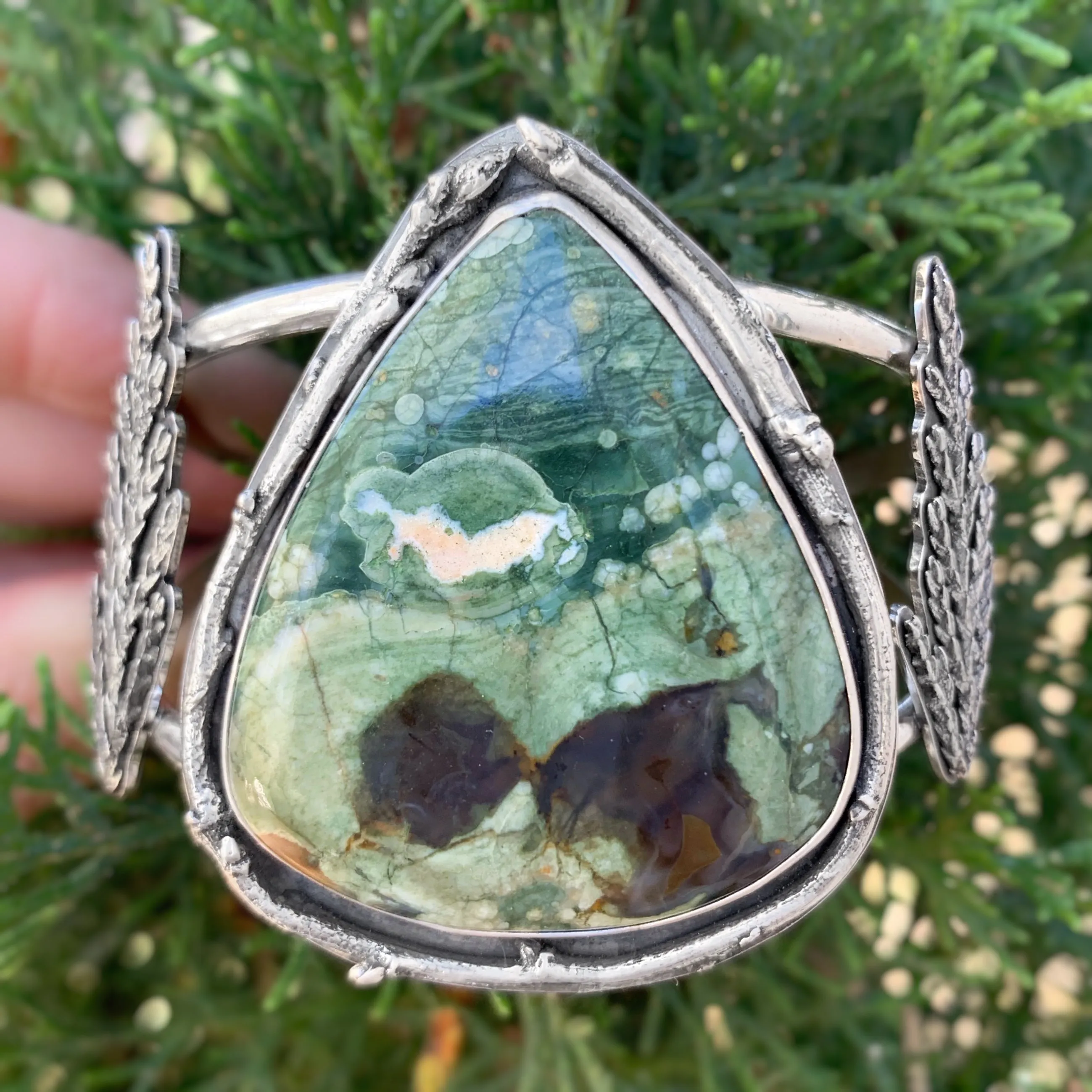 Opalized rhyolite cuff with cedar leaves and pine tree cut-out