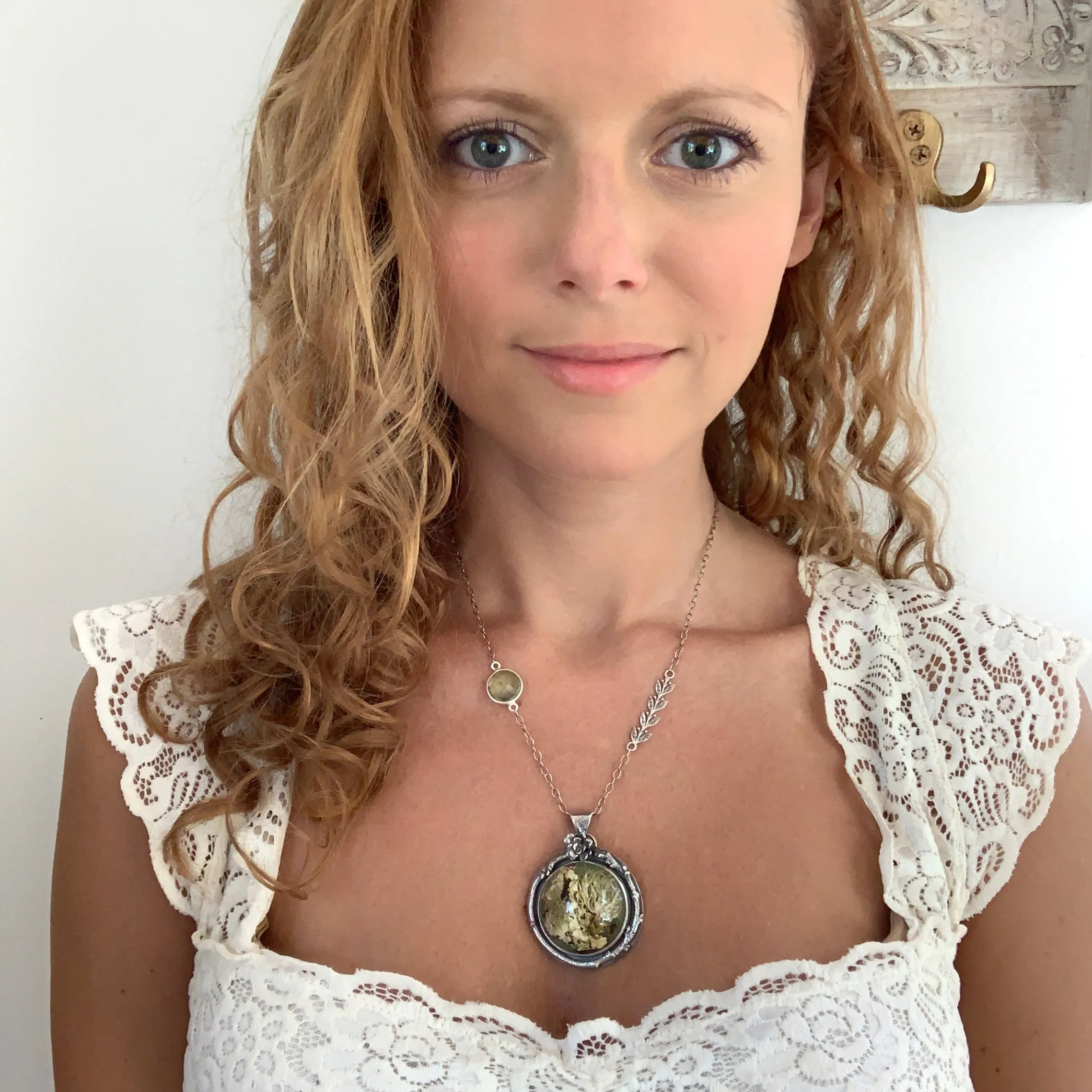 Silver nature necklace with lichen terrarium, green amethyst, silver vines, succulent, and twig