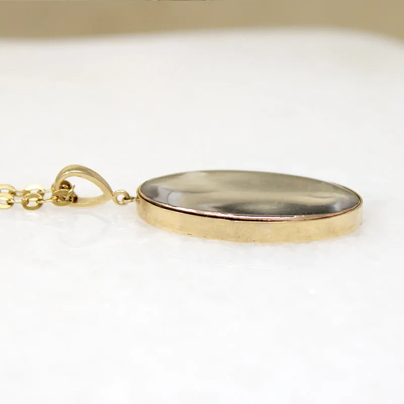 Somber Miniature Painting in Gold Pendant